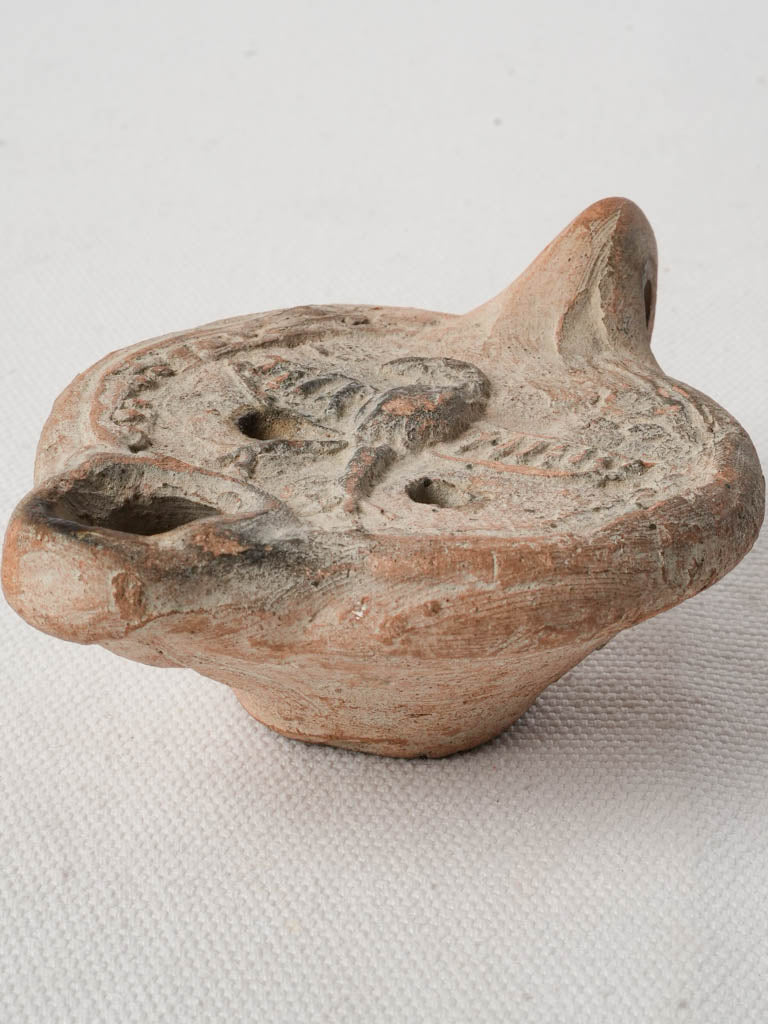 Ancient terracotta lamp with eagle