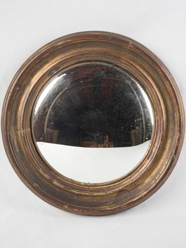 Aged gilded convex witch’s mirror  