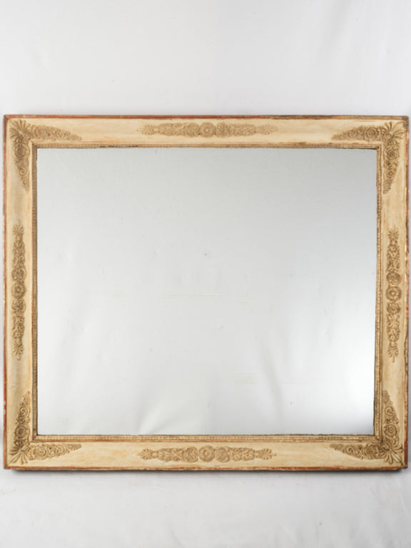 Antique ornate mirror with floral detailing  