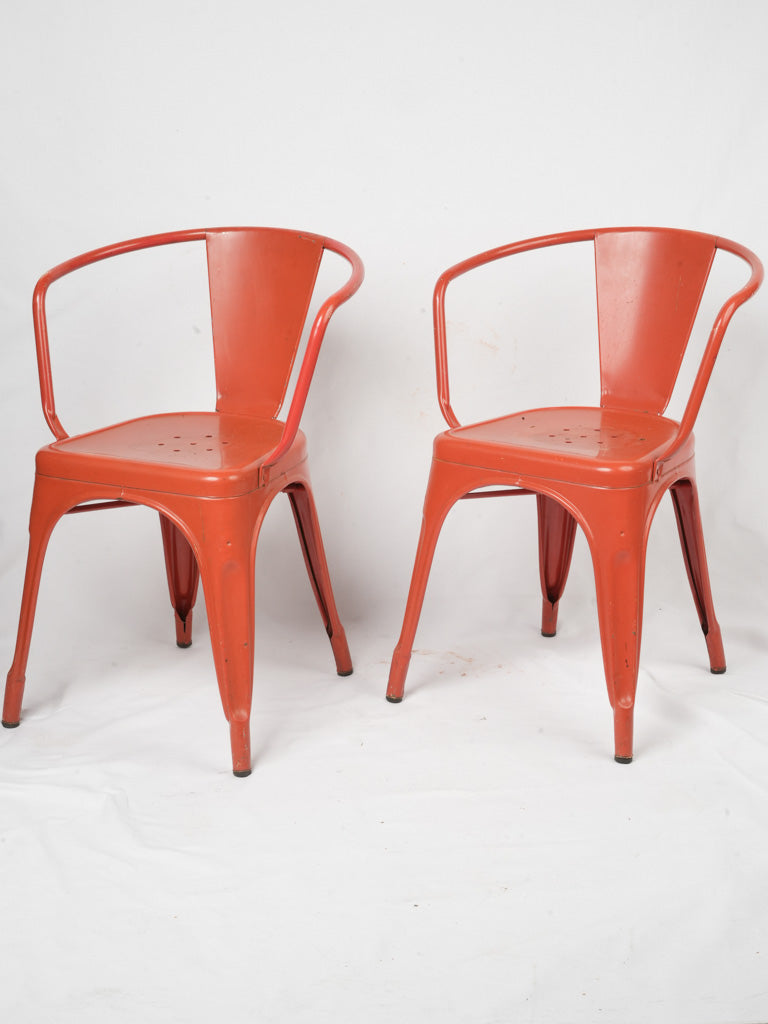 Vintage vibrant red metal armchairs